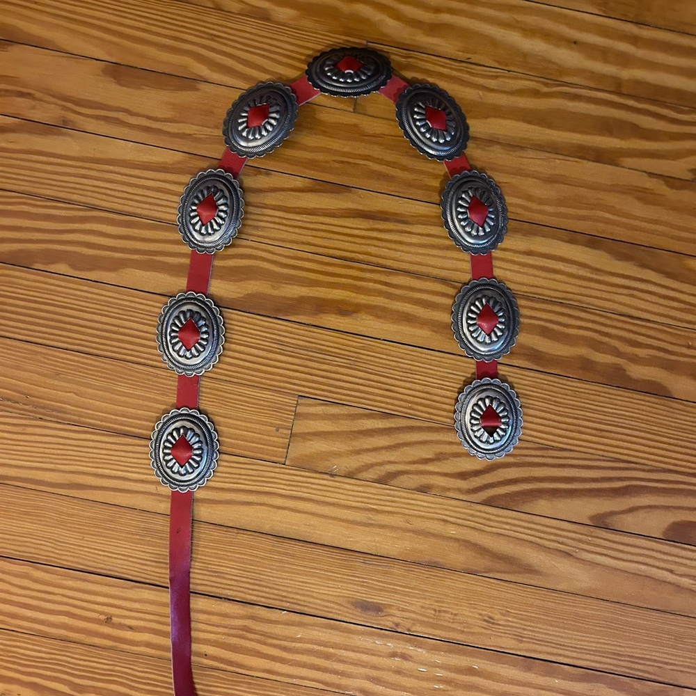 Vintage Western style belt, red faux leather, w silver Concho details.